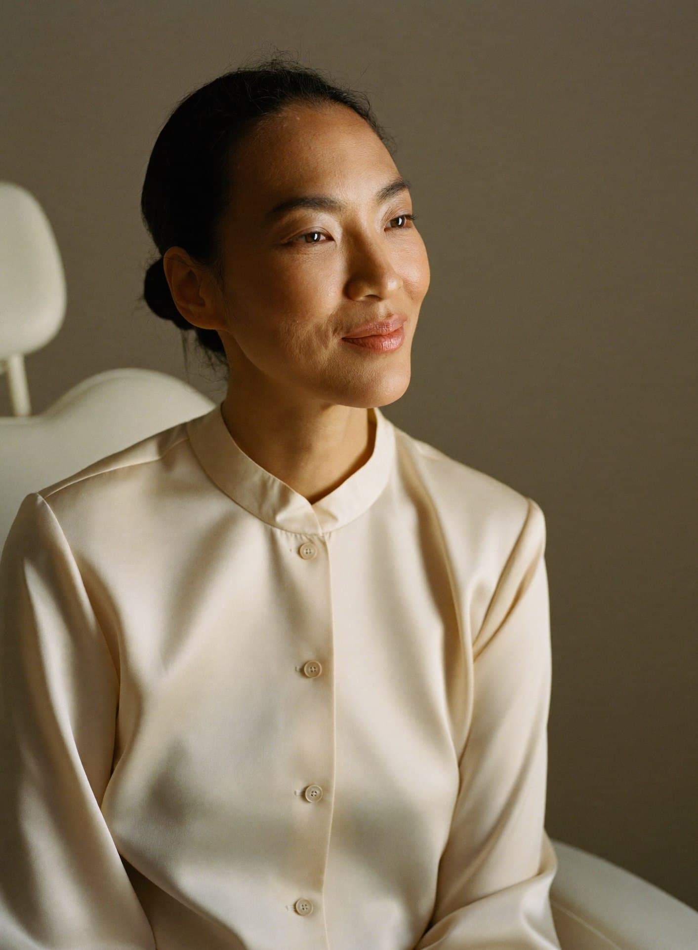 Portrait of Dr. Marielle Santiago, seated in the clinic in a cream blouse