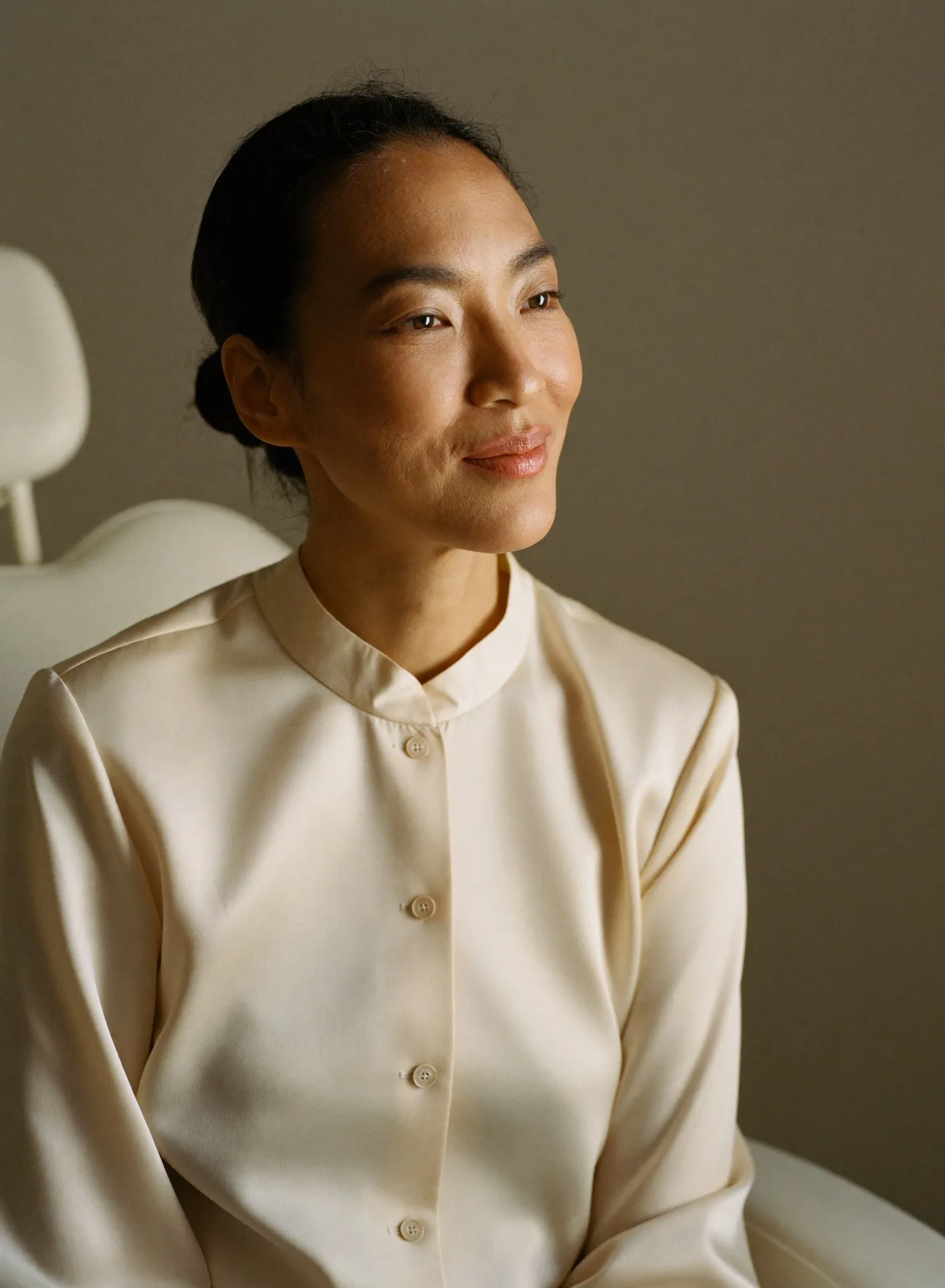 Portrait of Dr. Marielle Santiago, seated in the clinic in a cream blouse